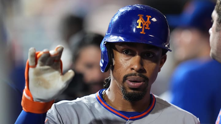 New York Mets infielder Francisco Lindor celebrates with teammates after hitting a home run.