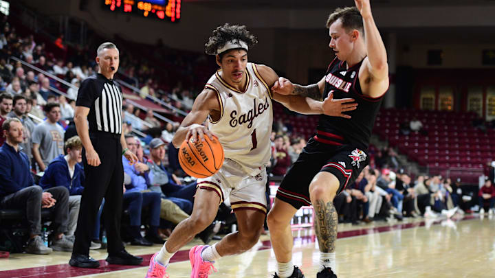Feb 5, 2025; Chestnut Hill, Massachusetts, USA; Boston College Eagles guard Dion Brown (1) controls the ball while Louisville Cardinals guard Reyne Smith (6) defends during the second half at Conte Forum. Mandatory Credit: Bob DeChiara-Imagn Images