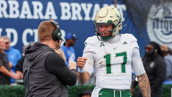 Memphis, Tennessee, USA; South Florida Bulls quarterback Byrum Brown (17) and head coach Alex Goulash (obscured) shake hands during the second quarter against the Memphis Tigers at Simmons Bank Liberty Stadium.