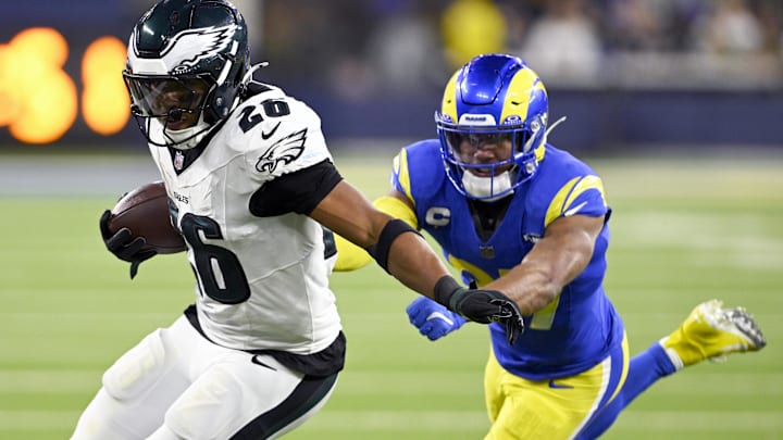 Nov 24, 2024; Inglewood, California, USA;  Philadelphia Eagles running back Saquon Barkley (26) runs past Los Angeles Rams safety Quentin Lake (right) during the second half at SoFi Stadium. Mandatory Credit: Alex Gallardo-Imagn Images
