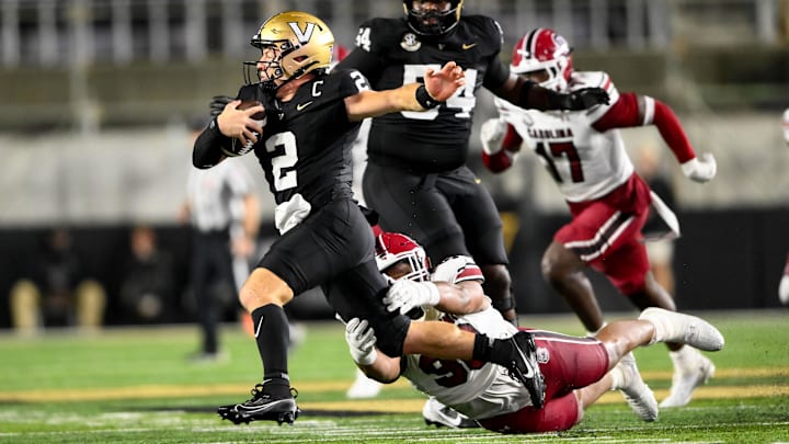 Nov 9, 2024; Nashville, Tennessee, USA;  Vanderbilt Commodores quarterback Diego Pavia (2) breaks the tackle of South Carolina Gamecocks defensive tackle T.J. Sanders (90) during the second half at FirstBank Stadium. Mandatory Credit: Steve Roberts-Imagn Images