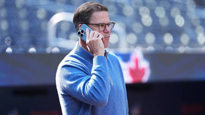 Sep 12, 2025; Toronto, Ontario, CAN; Toronto Blue Jays general manager Ross Atkins talks on the phone during batting practice before a game against the Baltimore Orioles at Rogers Centre. Mandatory Credit: Nick Turchiaro-Imagn Images
