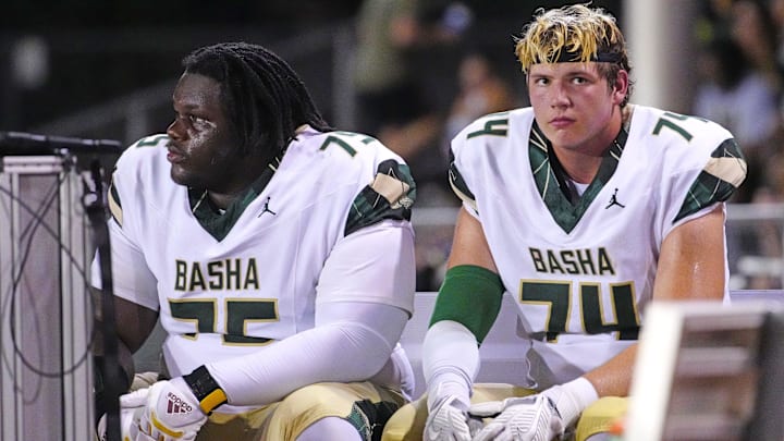 Basha tackles Dajohn Yarborough (75) and Jake Hildebrand (74) sit on the bench after another rushing touchdown against Brophy Prep during a game at Central High School in Phoenix on Aug. 28, 2025.