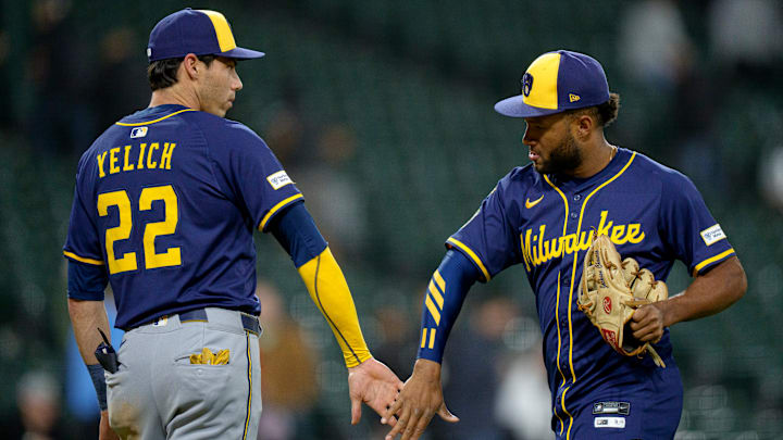 Milwaukee Brewers players Christian Yelich and Jackson Chourio celebrate a victory.