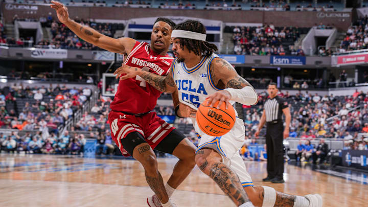 UCLA Bruins guard Skyy Clark (55) rushes up the court against Wisconsin Badgers guard Kamari McGee (4) on Friday, March 14, 2025, during the third round of the men's Big Ten tournament at Gainbridge Fieldhouse in Indianapolis. UCLA Bruins guard Skyy Clark (55) rushes up the court against Wisconsin Badgers guard Kamari McGee (4) on Friday, March 14, 2025, during the third round of the men's Big Ten tournament at Gainbridge Fieldhouse in Indianapolis.