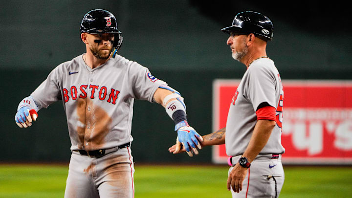 Sep 6, 2025; Phoenix, Arizona, USA; Boston Red Sox shortstop Trevor Story (10) and first base coach José David Flores (58) slap hands during the fourth inning at Chase Field. Mandatory Credit: Arianna Grainey-Imagn Images Sep 6, 2025; Phoenix, Arizona, USA; Boston Red Sox shortstop Trevor Story (10) and first base coach José David Flores (58) slap hands during the fourth inning at Chase Field. Mandatory Credit: Arianna Grainey-Imagn Images