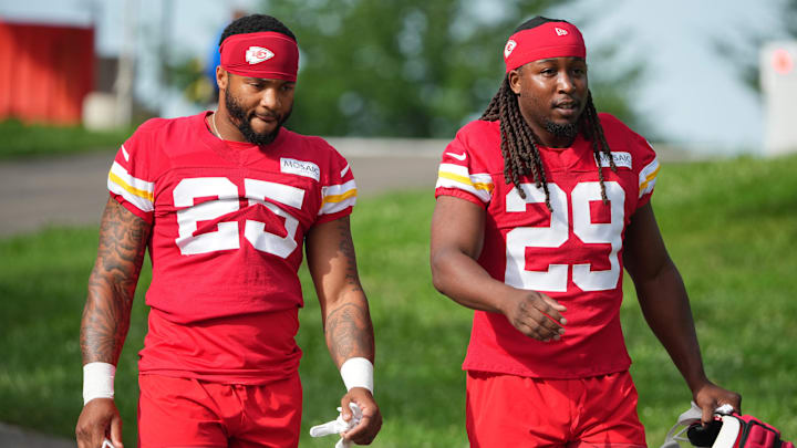Jul 22, 2025; St. Joseph, MO, USA; Kansas City Chiefs running backs Elijah Mitchell (25) and Kareem Hunt (29) walk down the hill to the fields prior to training camp at Missouri Western State University. Mandatory Credit: Denny Medley-Imagn Images