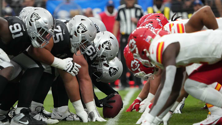 Oct 27, 2024; Paradise, Nevada, USA; Helmets at the line of scrimmage as Las Vegas Raiders long snapper Jacob Bobenmoyer (50) snaps the ball against the Kansas City Chiefs in the first half at Allegiant Stadium. Mandatory Credit: Kirby Lee-Imagn Images