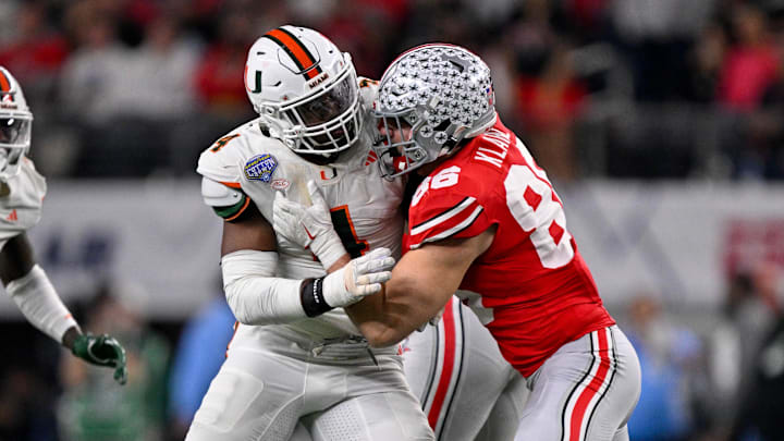 Dec 31, 2025; Arlington, TX, USA; Ohio State Buckeyes tight end Max Klare (86) blocks Miami Hurricanes defensive lineman Rueben Bain Jr. (4) during the 2025 Cotton Bowl and quarterfinal game of the College Football Playoff at AT&T Stadium. Mandatory Credit: Jerome Miron-Imagn Images