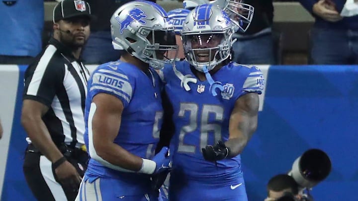  running backs , left, and Jahmyr Gibbs celebrate a Gibbs touchdown