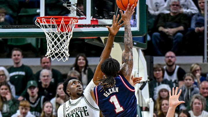 Michigan State's Xavier Booker, left, pressures Florida Atlantic's Kaleb Glenn on a shot during the first half on Saturday, Dec. 21, 2024, in East Lansing.
