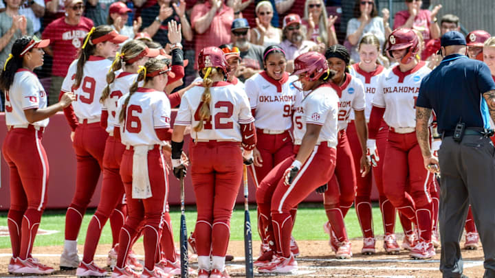 Oklahoma greets Ella Parker at the plate after hitting a home run in the NCAA Tournament against Binghamton.