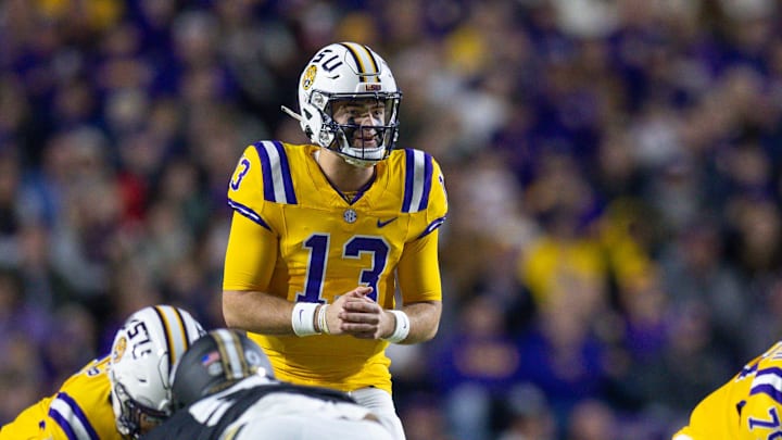 Nov 23, 2024; Baton Rouge, Louisiana, USA;  LSU Tigers quarterback Garrett Nussmeier (13) looks over the Vanderbilt Commodores defense during the first half at Tiger Stadium. Mandatory Credit: Stephen Lew-Imagn Images