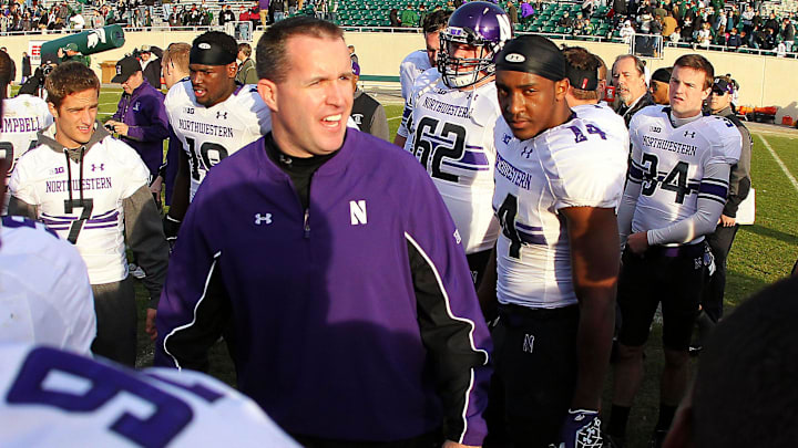 November 17, 2012; East Lansing, MI, USA; Northwestern Wildcats head coach Pat Fitzgerald talks to his team after the game at Spartan Stadium against the Michigan State Spartans.     Mandatory Credit: Mike Carter-Imagn Images