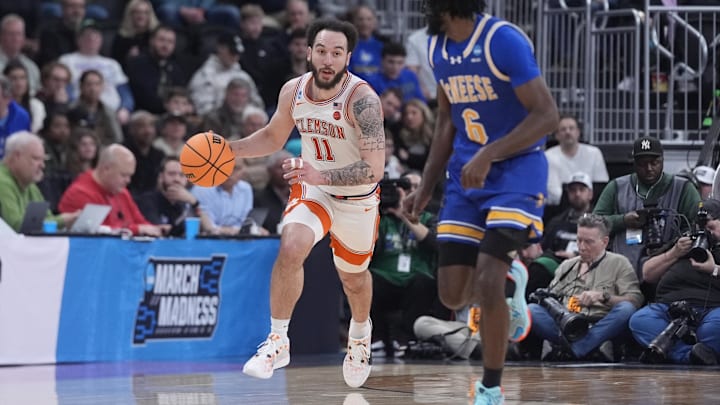 Mar 20, 2025; Providence, RI, USA; Clemson Tigers guard Jaeden Zackery (11) brings the ball up court against McNeese State Cowboys guard Javohn Garcia (6) during the second half at Amica Mutual Pavilion. Mandatory Credit: Gregory Fisher-Imagn Images