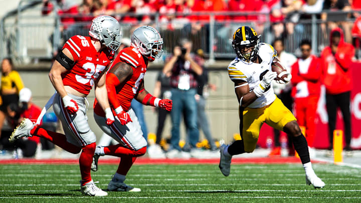 Iowa running back Kaleb Johnson (2) rushes as Ohio State linebacker Tommy Eichenberg (35) and Ohio State defensive tackle Michael Hall Jr., (51) close in on him during a NCAA football game, Saturday, Oct. 22, 2022, at Ohio Stadium in Columbus, Ohio.