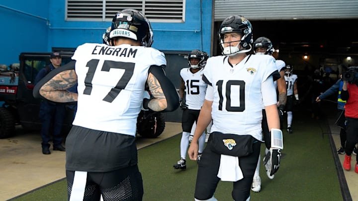 Dec 8, 2024; Nashville, Tennessee, USA;  Jacksonville Jaguars quarterback Mac Jones (10) and tight end Evan Engram (17) take the field against the Tennessee Titans during the first half at Nissan Stadium. Mandatory Credit: Steve Roberts-Imagn Images