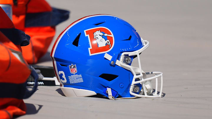 Oct 6, 2024; Denver, Colorado, USA; Detailed view of the throw back helmets worn by the Denver Broncos before the game against the Las Vegas Raiders at Empower Field at Mile High. Mandatory Credit: Ron Chenoy-Imagn Images