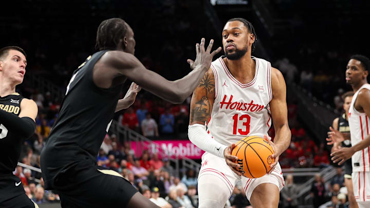 Mar 13, 2025; Kansas City, MO, USA; Houston Cougars forward J'Wan Roberts (13) brings the ball up court during the first half against the Colorado Buffaloes at T-Mobile Center. Mandatory Credit: William Purnell-Imagn Images
