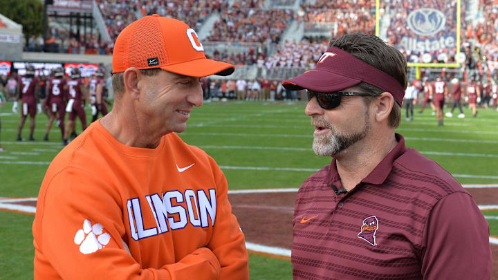 Nov 9, 2024; Blacksburg, Virginia, USA;  Virginia Tech Hokies head coach Brent Pry and Clemson Tigers head coach Dabo Swinney talk before the game at Lane Stadium. Mandatory Credit: Brian Bishop-Imagn Images