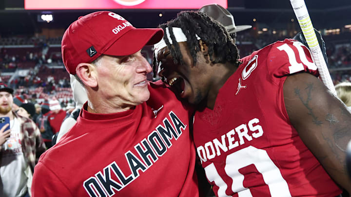 Oklahoma coach Brent Venables embraces linebacker Kip Lewis