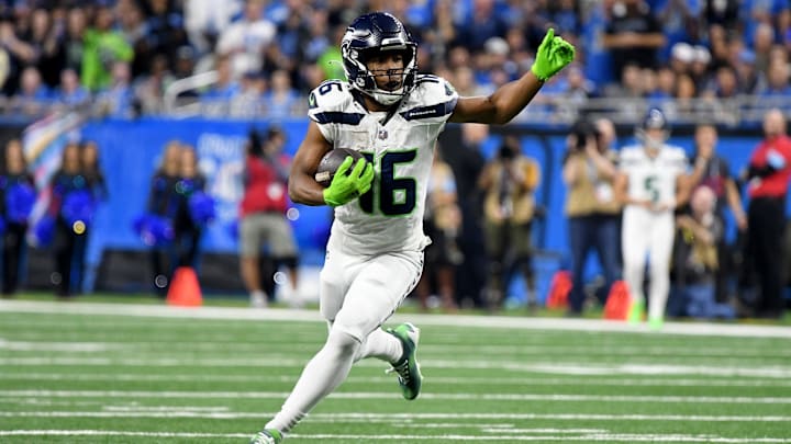 Sep 30, 2024; Detroit, Michigan, USA; Seattle Seahawks wide receiver Tyler Lockett (16) runs the ball against the Detroit Lions in the third quarter at Ford Field. Mandatory Credit: Eamon Horwedel-Imagn Images