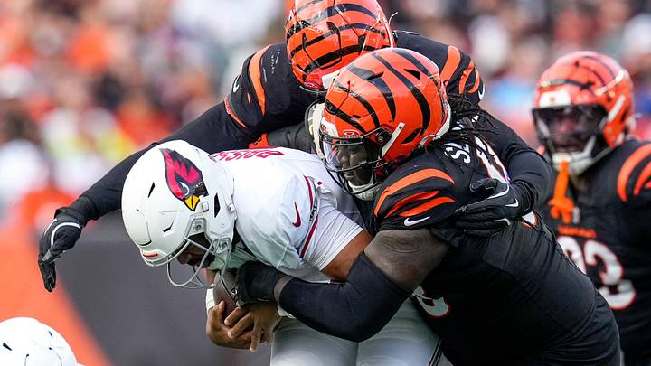 Cincinnati Bengals defensive tackle T.J. Slaton Jr. (98) pulls down Arizona Cardinals quarterback Jacoby Brissett (7) in the third quarter of the NFL Week 17 game between the Cincinnati Bengals and the Arizona Cardinals at Paycor Stadium in Downtown Cincinnati on Sunday, Dec. 28, 2025. The Bengals won 37-14. Cincinnati Bengals defensive tackle T.J. Slaton Jr. (98) pulls down Arizona Cardinals quarterback Jacoby Brissett (7) in the third quarter of the NFL Week 17 game between the Cincinnati Bengals and the Arizona Cardinals at Paycor Stadium in Downtown Cincinnati on Sunday, Dec. 28, 2025. The Bengals won 37-14.