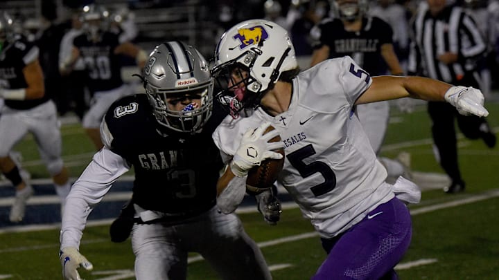 Granville junior Mikey Chaykowski pursues DeSales' Kyle Nicely during Friday night's Division III, Region 11 quarterfinal at Walter Hodges Stadium. The Blue Aces defeated the visiting Stallions 19-12 and will face London in the regional semifinals.

Granville 19 Desales 12
