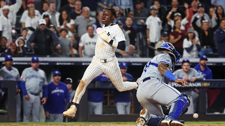 Oct 5, 2024; Bronx, New York, USA; New York Yankees third base Jazz Chisholm Jr. (13) scores a run as Kansas City Royals catcher Salvador Perez (13) was unable to make a save during the seventh inning during game one of the ALDS for the 2024 MLB Playoffs at Yankee Stadium. Mandatory Credit: Vincent Carchietta-Imagn Images