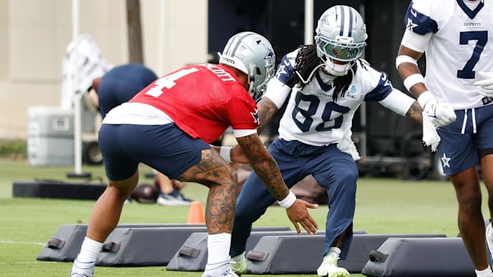 Dallas Cowboys QB Dak Prescott celebrates with WR CeeDee Lamb during a drill at the Ford Center at the Star Training Facility.