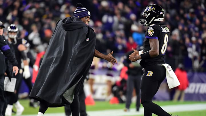Baltimore Ravens quarterback Lamar Jackson (8) is congratulated by Robert Griffin III (3) after scoring a touchdown in the first quarter against the New York Jets at M&T Bank Stadium. 