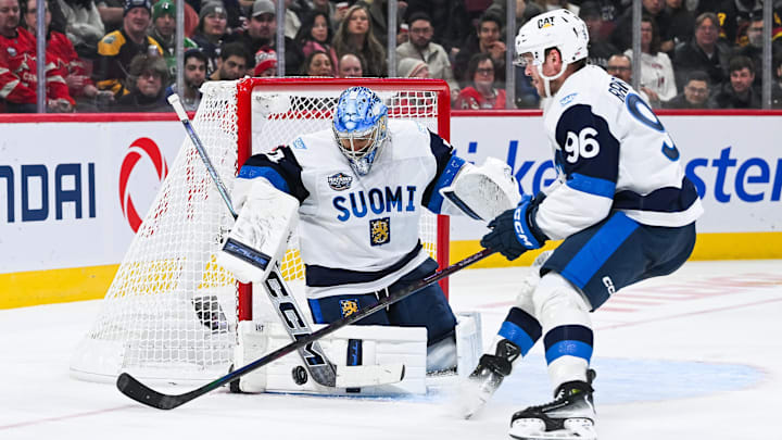 Feb 13, 2025; Montreal, Quebec, CAN; [Imagn Images direct customers only] Team Finland goalie Juuse Saros (74) makes a save near forward Mikko Rantanen (96) against Team USA in the third period during a 4 Nations Face-Off ice hockey game at Bell Centre. Mandatory Credit: David Kirouac-Imagn Images