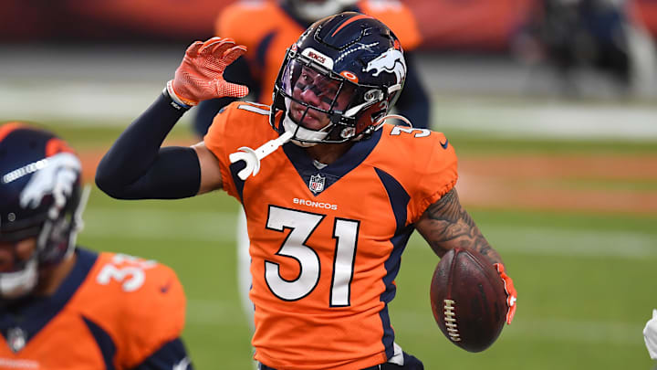 Jan 3, 2021; Denver, Colorado, USA; Denver Broncos free safety Justin Simmons (31) celebrates his interception in the fourth quarter against the Las Vegas Raiders at Empower Field at Mile High. Mandatory Credit: Ron Chenoy-Imagn Images