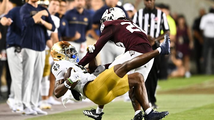 Aug 31, 2024; College Station, Texas, USA; Notre Dame Fighting Irish wide receiver Beaux Collins (5) catches a pass as Texas A&M Aggies defensive back Dashawn Fillmore (26) attempts to break up the play in the fourth quarter at Kyle Field. Mandatory Credit: Maria Lysaker-Imagn Images