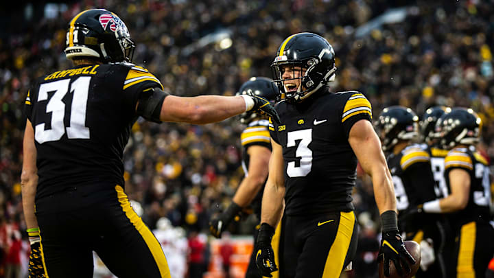 Iowa defensive back Cooper DeJean (3) celebrates with linebacker Jack Campbell after returning an intercepted pass for a touchdown during a NCAA Big Ten Conference football game against Wisconsin, Saturday, Nov. 12, 2022, at Kinnick Stadium in Iowa City, Iowa.