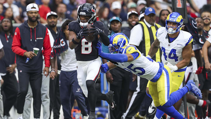 Aug 24, 2024; Houston, Texas, USA; Houston Texans wide receiver John Metchie III (8) runs with the ball as Los Angeles Rams safety Jason Taylor II (25) attempts to make a tackle during the first quarter at NRG Stadium.