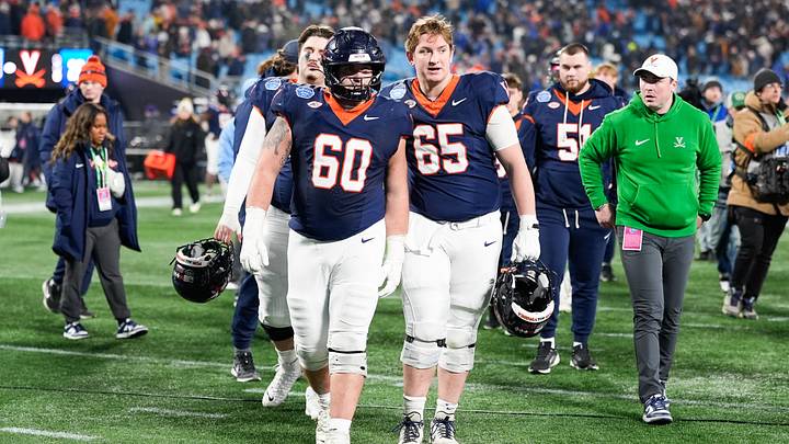 Dec 6, 2025; Charlotte, NC, USA; Virginia Cavaliers offensive lineman Drake Metcalf (60) and offensive lineman Grant Ellinger (65) waolk off the field after the game against the Duke Blue Devils during the 2025 ACC Championship game at Bank of America Stadium. Mandatory Credit: Jim Dedmon-Imagn Images Dec 6, 2025; Charlotte, NC, USA; Virginia Cavaliers offensive lineman Drake Metcalf (60) and offensive lineman Grant Ellinger (65) waolk off the field after the game against the Duke Blue Devils during the 2025 ACC Championship game at Bank of America Stadium. Mandatory Credit: Jim Dedmon-Imagn Images