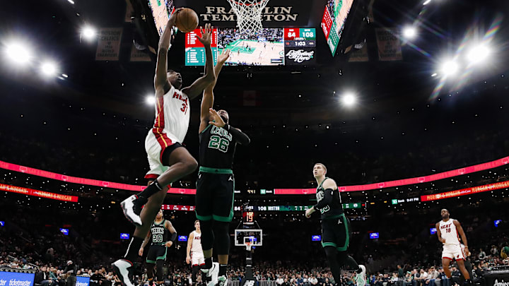 Dec 2, 2024; Boston, Massachusetts, USA: Miami Heat center Thomas Bryant (31) goes to the basket against Boston Celtics forward Xavier Tillman (26) during the second half at TD Garden. Mandatory Credit: Winslow Townson-Imagn Images