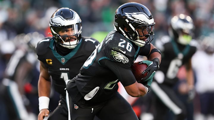 Nov 28, 2025; Philadelphia, Pennsylvania, USA; Philadelphia Eagles quarterback Jalen Hurts (1) hands the ball to Philadelphia Eagles running back Saquon Barkley (26) against the Chicago Bears during the second quarter of the game at Lincoln Financial Field. Mandatory Credit: Bill Streicher-Imagn Images