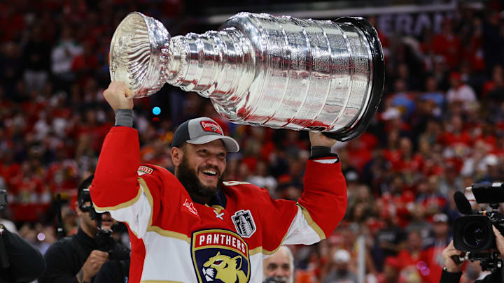 Jun 24, 2024; Sunrise, Florida, USA; Florida Panthers forward Kyle Okposo (8) hoists the Stanley Cup after defeating the Edmonton Oilers in game seven of the 2024 Stanley Cup Final at Amerant Bank Arena. Mandatory Credit: Sam Navarro-Imagn Images Jun 24, 2024; Sunrise, Florida, USA; Florida Panthers forward Kyle Okposo (8) hoists the Stanley Cup after defeating the Edmonton Oilers in game seven of the 2024 Stanley Cup Final at Amerant Bank Arena. Mandatory Credit: Sam Navarro-Imagn Images