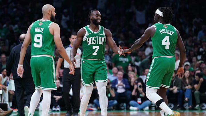 Oct 22, 2024; Boston, Massachusetts, USA: Boston Celtics guard Jaylen Brown (7), guard Jrue Holiday (4) and guard Derrick White (9) react after a play against the New York Knicks in the second half at TD Garden. Mandatory Credit: David Butler II-Imagn Images