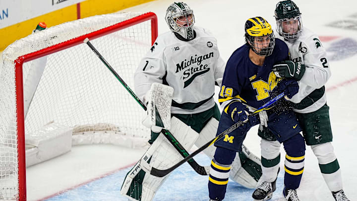 Michigan State goaltender Trey Augustine (1), left, tends net against Michigan forward Michael Hage (19) during the second period of Duel in the D at Little Caesars Arena in Detroit on Saturday, February 7, 2026.