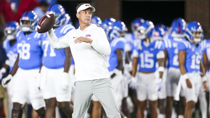 Nov 15, 2025; Oxford, Mississippi, USA; Mississippi Rebels head coach Lane Kiffin throws a football during pregame warmups against the Florida Gators at Vaught-Hemingway Stadium. Mandatory Credit: Petre Thomas-Imagn Images