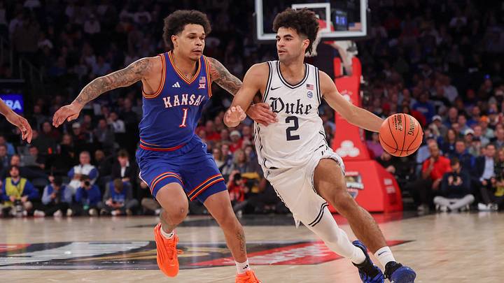 Nov 18, 2025; New York, New York, USA; Duke Blue Devils guard Cayden Boozer (2) dribbles as Kansas Jayhawks guard Jayden Dawson (1) defends during the second half at Madison Square Garden. Mandatory Credit: Vincent Carchietta-Imagn Images