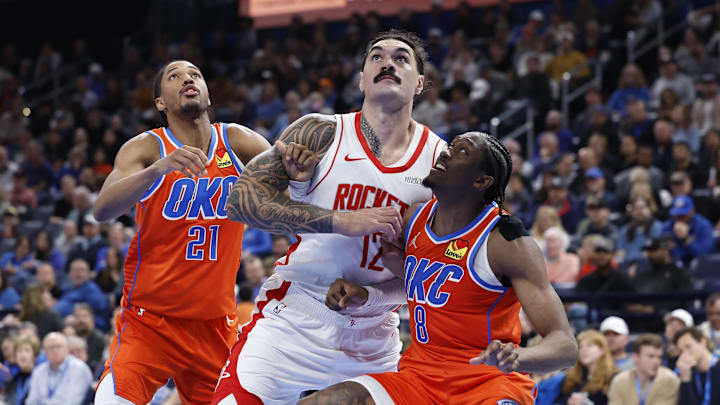 Nov 8, 2024; Oklahoma City, Oklahoma, USA; Houston Rockets center Steven Adams (12) fights for position with Oklahoma City Thunder guard Aaron Wiggins (21) and forward Jalen Williams (8) for a rebound during the second half at Paycom Center. Mandatory Credit: Alonzo Adams-Imagn Images