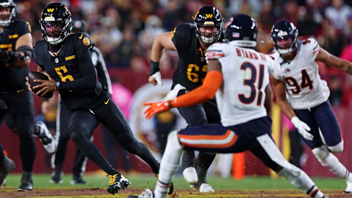 Kevin Byard and Austin Booker give chase to  Jayden Daniels on a run last season in Washington's 18-15 win over the Bears.