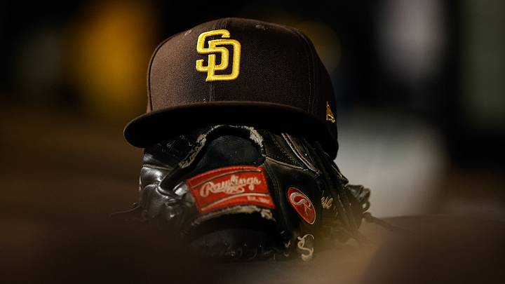 Jun 17, 2022; Denver, Colorado, USA; A detail view of a San Diego Padres hat on a glove in the dugout in the ninth inning against the Colorado Rockies at Coors Field. Mandatory Credit: Isaiah J. Downing-USA TODAY Sports Jun 17, 2022; Denver, Colorado, USA; A detail view of a San Diego Padres hat on a glove in the dugout in the ninth inning against the Colorado Rockies at Coors Field. Mandatory Credit: Isaiah J. Downing-USA TODAY Sports