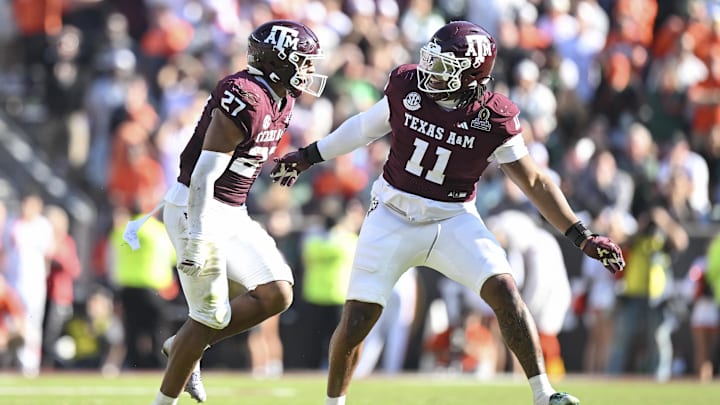 Texas A&M Aggies linebacker Daymion Sanford reacts with defensive tackle Tyler Onyedim after recovering a fumble against the Miami Hurricanes during the second half of the first round game of the CFP National Playoff at Kyle Field.