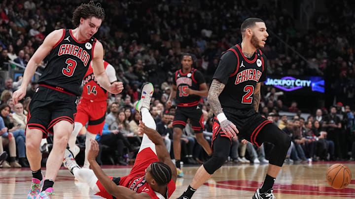 Dec 16, 2024; Toronto, Ontario, CAN; Toronto Raptors guard Ochai Agbaji (30) battles for the ball with Chicago Bulls guard Josh Giddey (3) during the second quarter at Scotiabank Arena. Mandatory Credit: Nick Turchiaro-Imagn Images