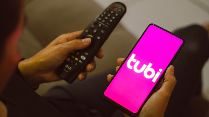 In this photo illustration, the Tubi logo seen displayed on...